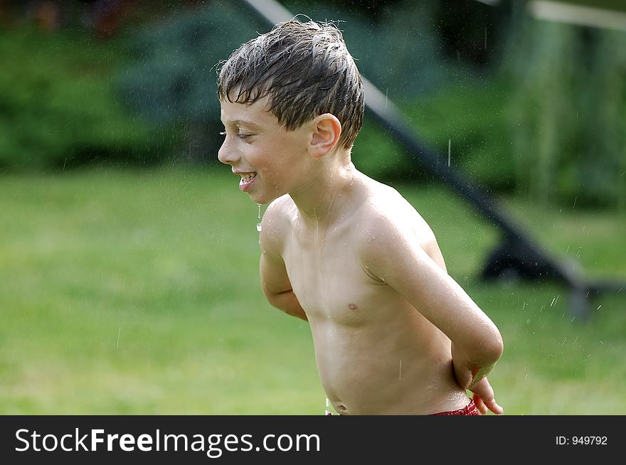Child Playing in Sprinkler. Child Playing in Sprinkler