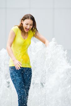 Young Caucasian Girl Playing At Fountain Royalty Free Stock Image