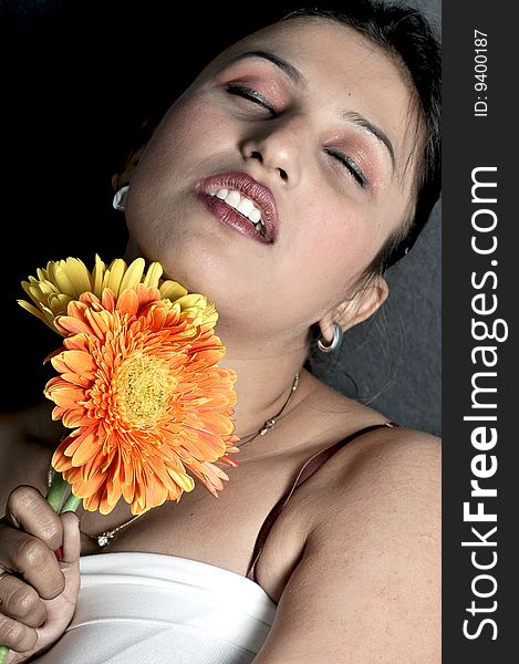 Girl with flower looking beautiful in studio.