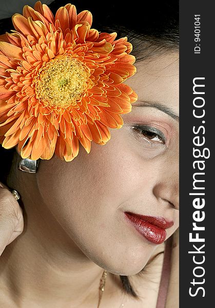 Smiling girl with gerbera flower