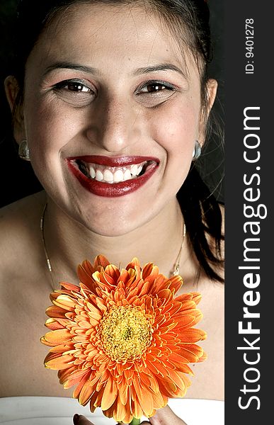 Smiling girl with gerbera flower