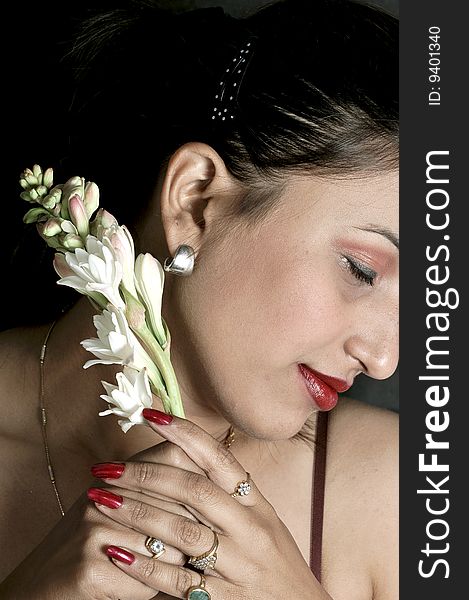 Girl with flower looking beautiful in studio.