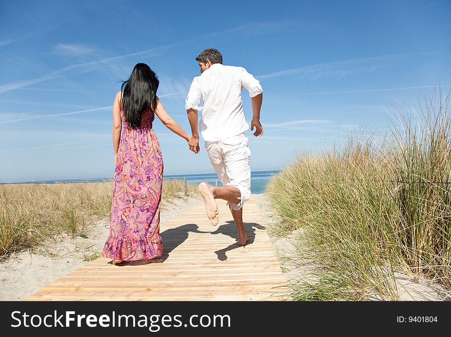 Couple running to the beach. Couple running to the beach