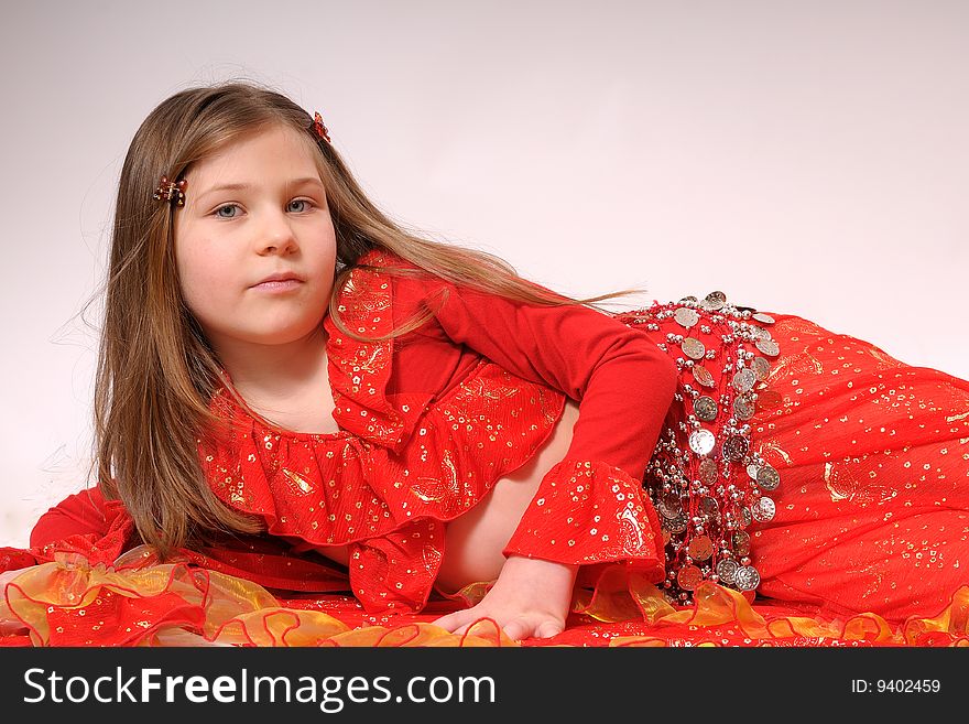 Portrait of a small gipsy girl dressed with red clothes