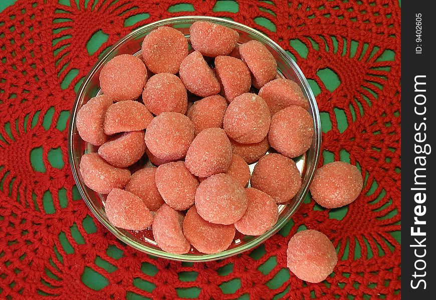 Jelly sugary sweets in glass plate on the red doily. Jelly sugary sweets in glass plate on the red doily