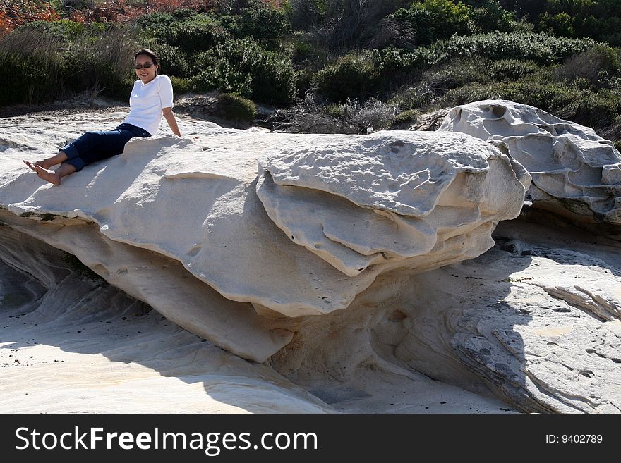 A woman relaxing on the headland in sydney