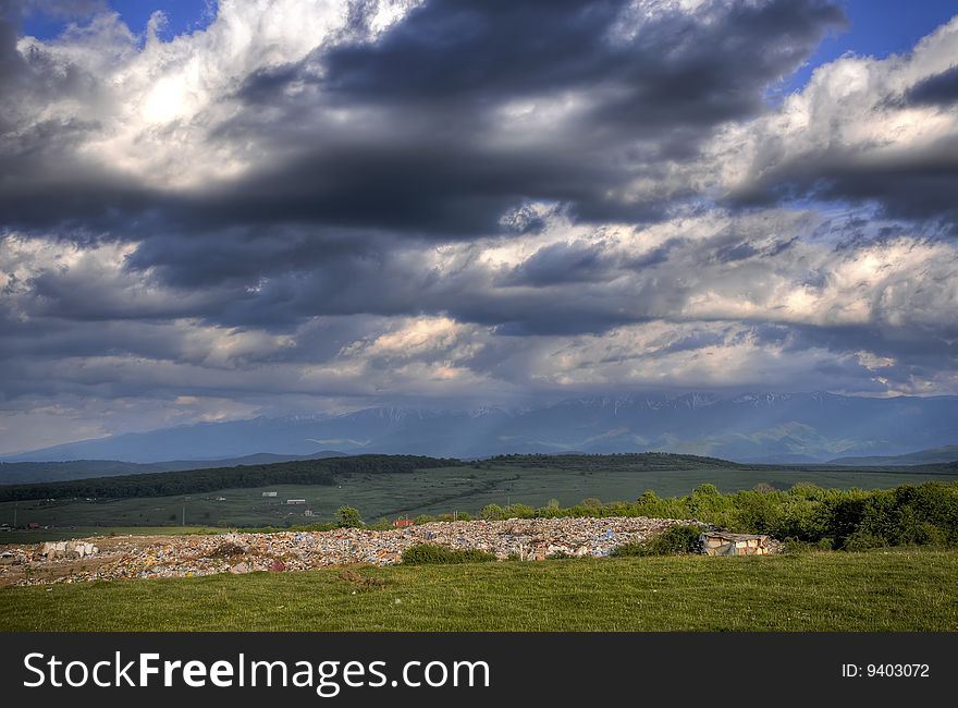 Landscape with dramatic sky and large junk yard. Landscape with dramatic sky and large junk yard