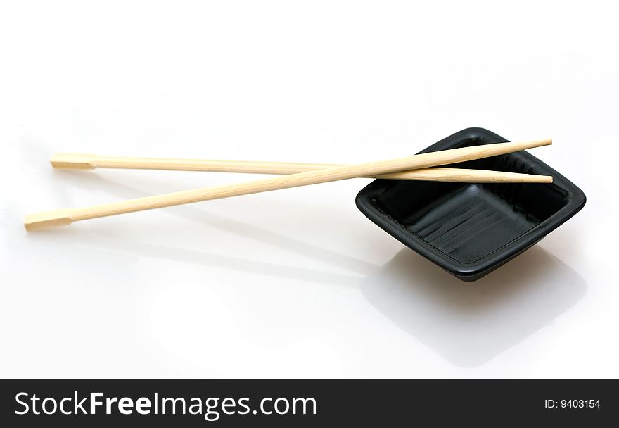 Chopsticks and a wasabi dish isolated