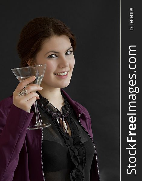 Pretty girl with a cocktail on black background. Pretty girl with a cocktail on black background