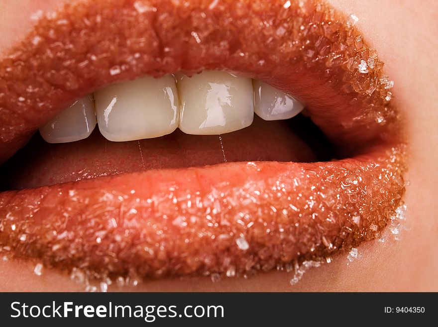 Woman's red lips coated with scattered sugar. Woman's red lips coated with scattered sugar