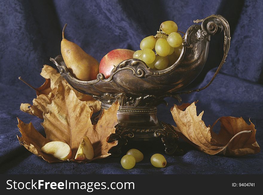 Autumn still life with fruits and leafs