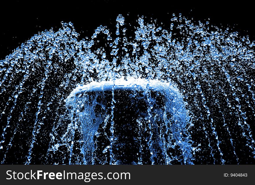 Sparks of blue water on a black background