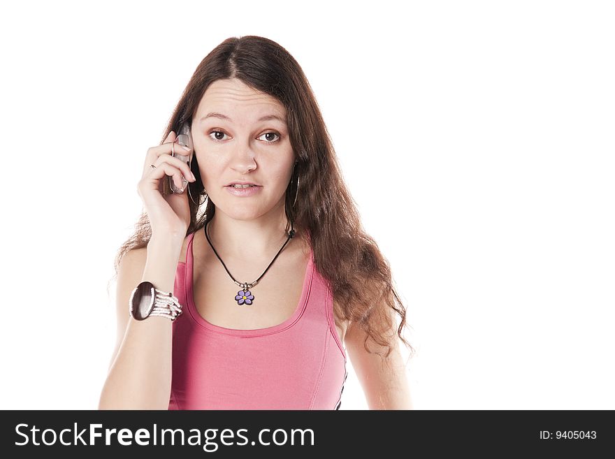 The girl speaks by a mobile phone. Isolated over white. The girl speaks by a mobile phone. Isolated over white.