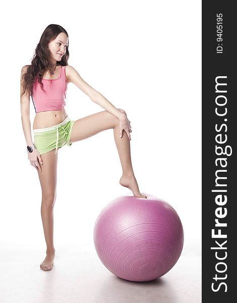 Sport girl and ball. Isolated over white.