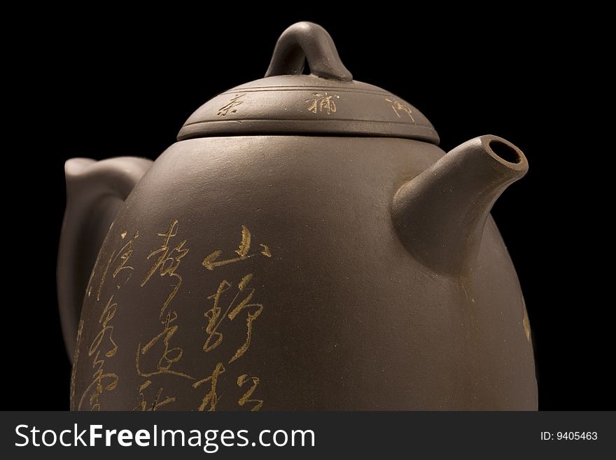 Half of teapot  with clipping path over black background. Half of teapot  with clipping path over black background