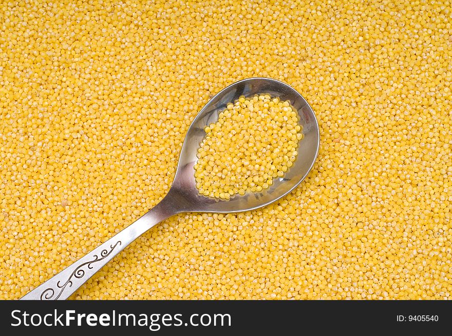 Millet background, yellow small groats, close-up, cooking ingredients