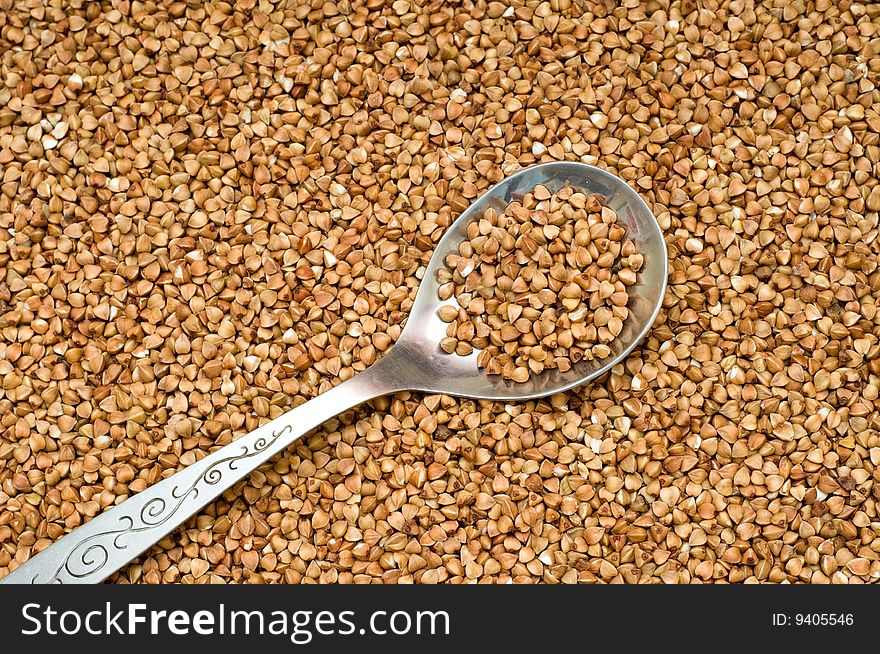 Buckwheat brown  background, close-up, cooking ingredients. Buckwheat brown  background, close-up, cooking ingredients