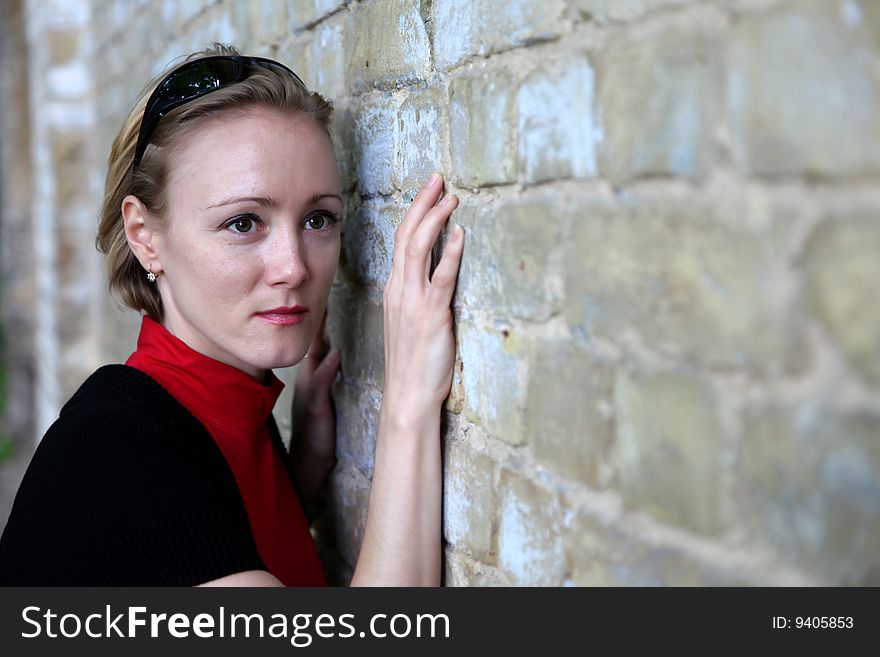 Yonug beautiful woman near wall