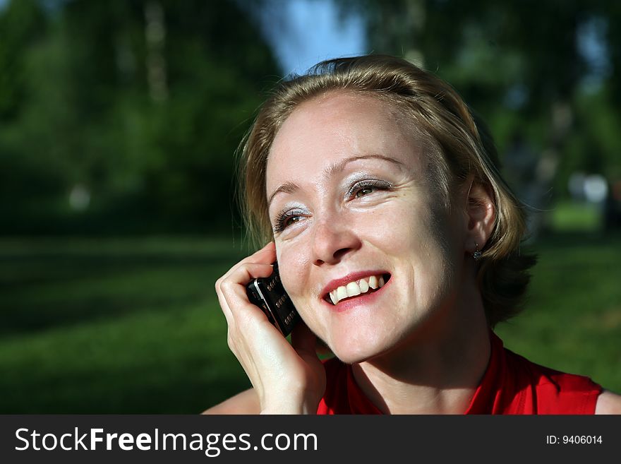 Woman talks on a mobile phone. Woman talks on a mobile phone
