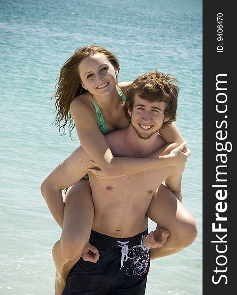 A young couple on the beach having fun. A young couple on the beach having fun