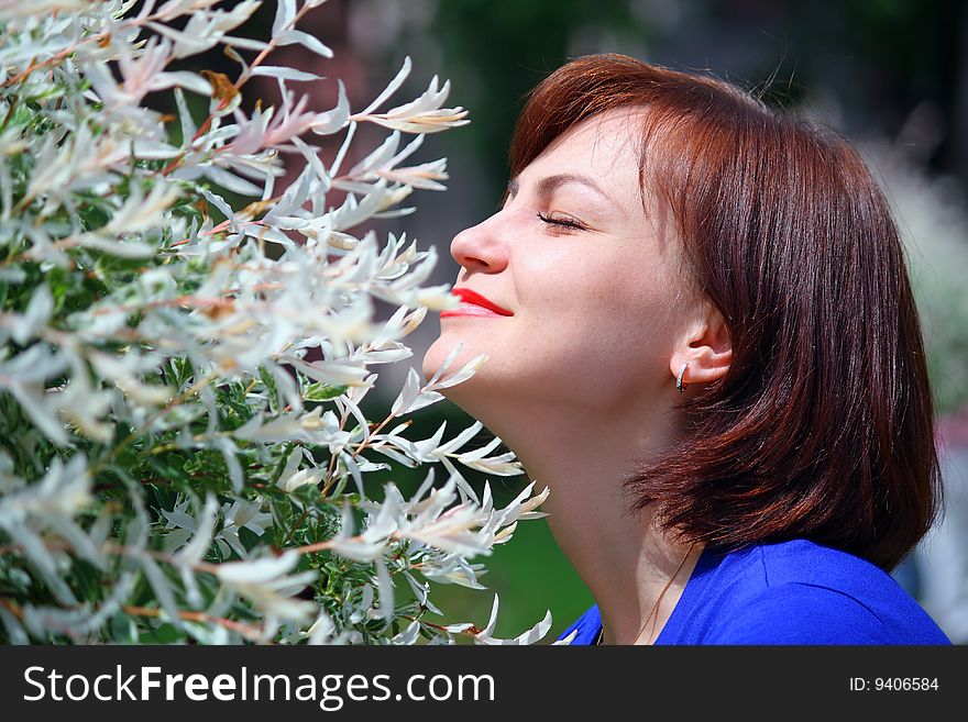 The girl in park feels the smells of spring forgotten for a winter