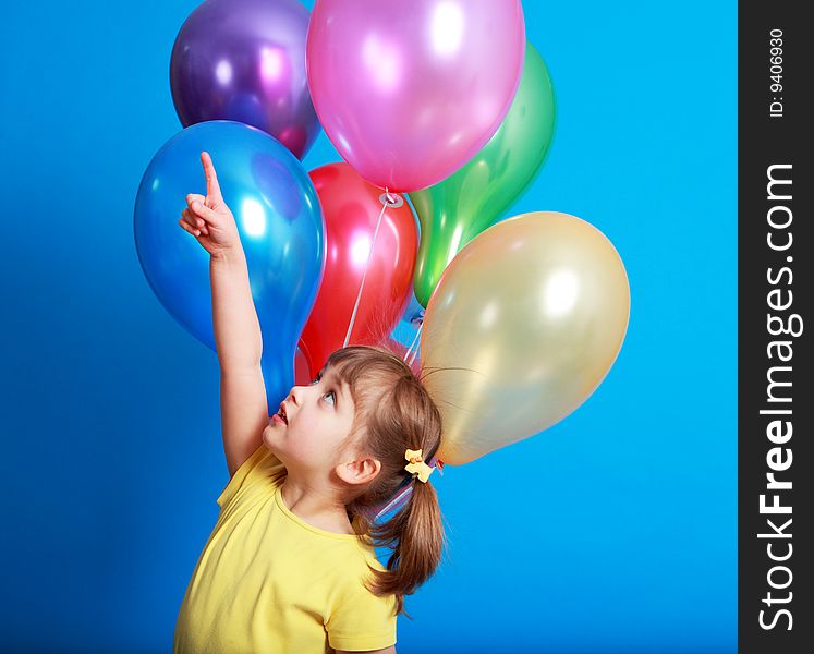 Little girl holding colorful balloons on a blue background