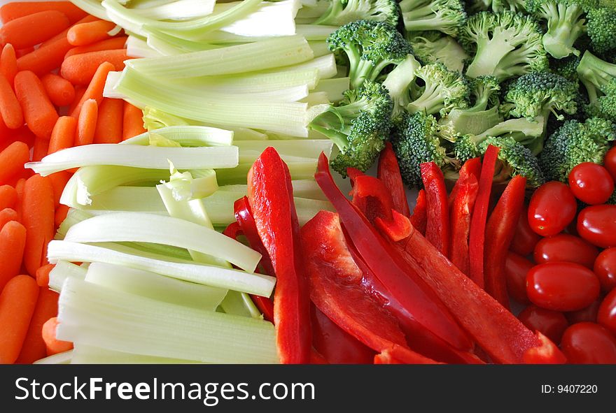 A vegetable platter of carrots, celery, peppers, ,tomatoes and broccoli. A vegetable platter of carrots, celery, peppers, ,tomatoes and broccoli
