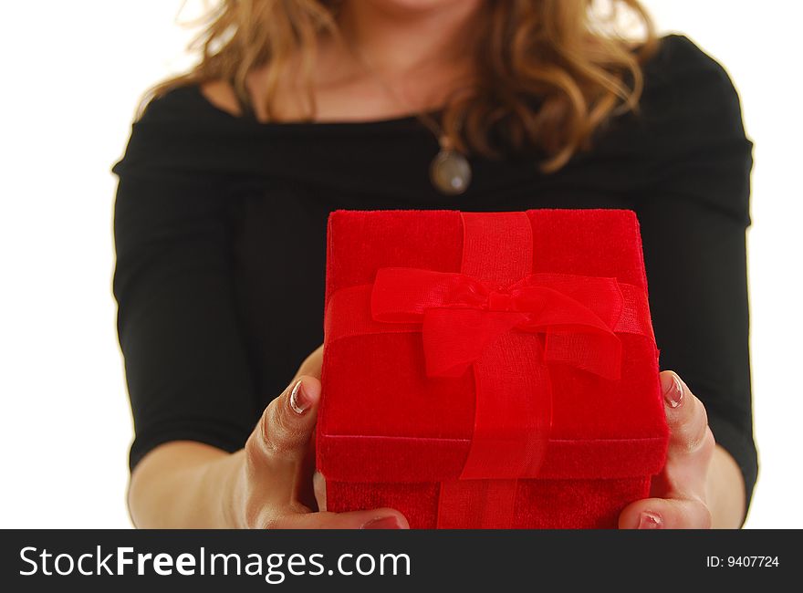 Caucasian woman giving a red gift. Shallow depth of field. Focus on present. Caucasian woman giving a red gift. Shallow depth of field. Focus on present.