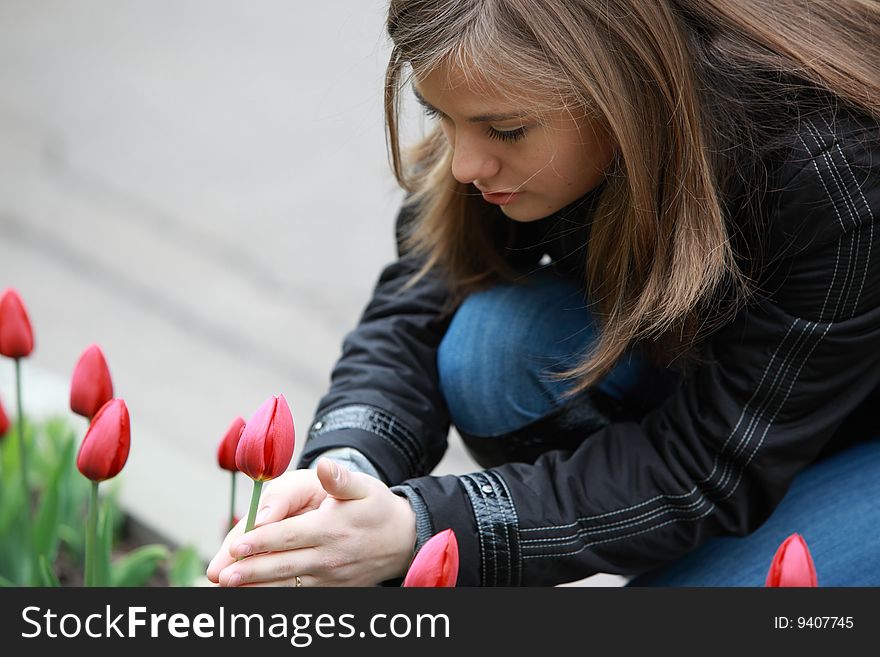 Teenager with tulips in park. Teenager with tulips in park