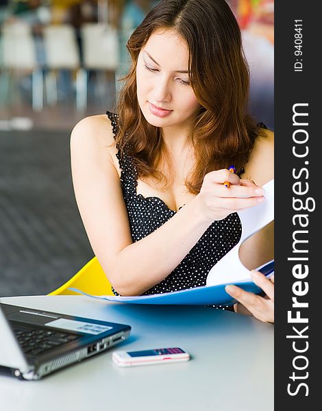 A young pretty caucasian lady using laptop outdoors