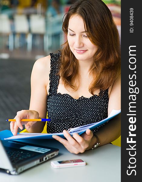 Young pretty caucasian lady using laptop outdoors