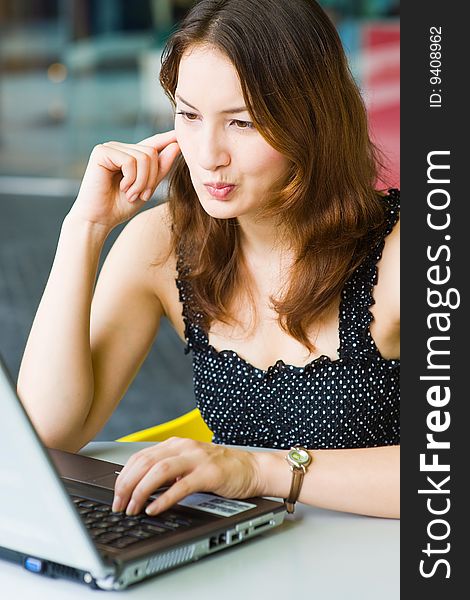 Young pretty caucasian lady using laptop outdoors