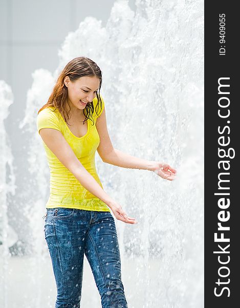 Young Caucasian Girl Playing At Fountain