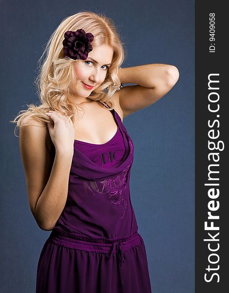 Beautiful young blonde girl  in purple dress