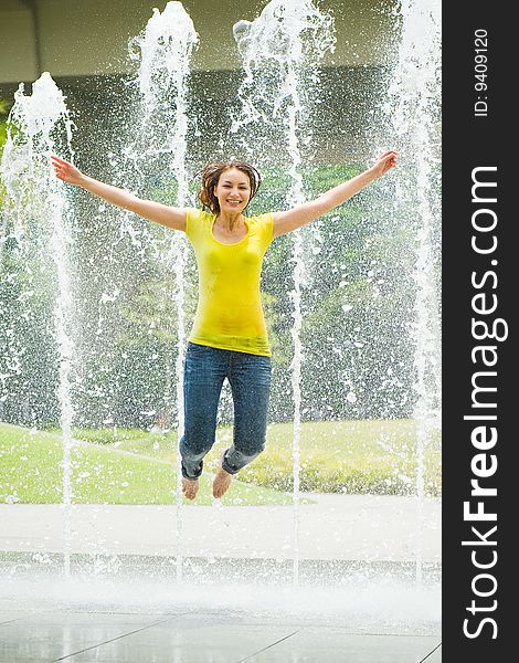 Young Caucasian Girl Playing At Fountain