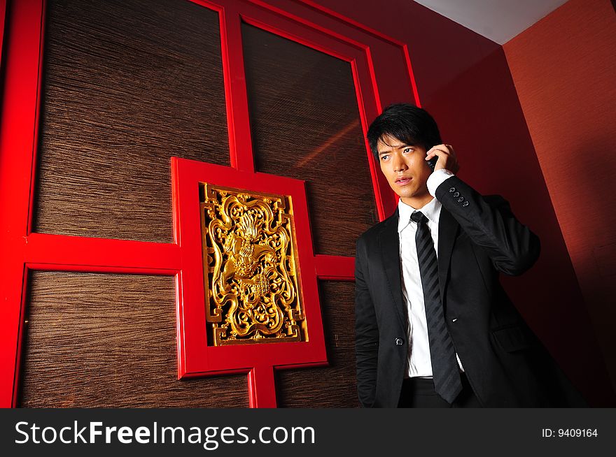 Smart Asian man in business suit in chinese temple. Smart Asian man in business suit in chinese temple