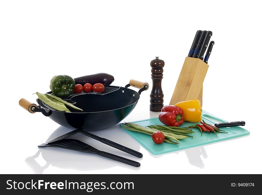 Preparing wok with fresh vegetables on cutting-board, white background,