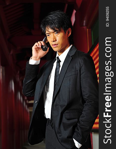 Asian man in business suit with Mobile Phone. Asian man in business suit with Mobile Phone