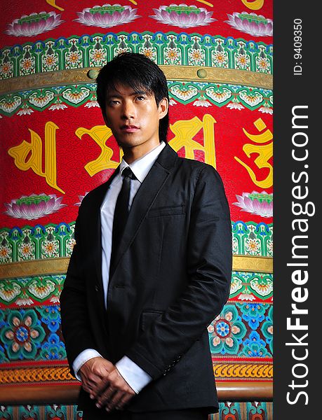 Smart Asian man in business suit in chinese temple. Smart Asian man in business suit in chinese temple