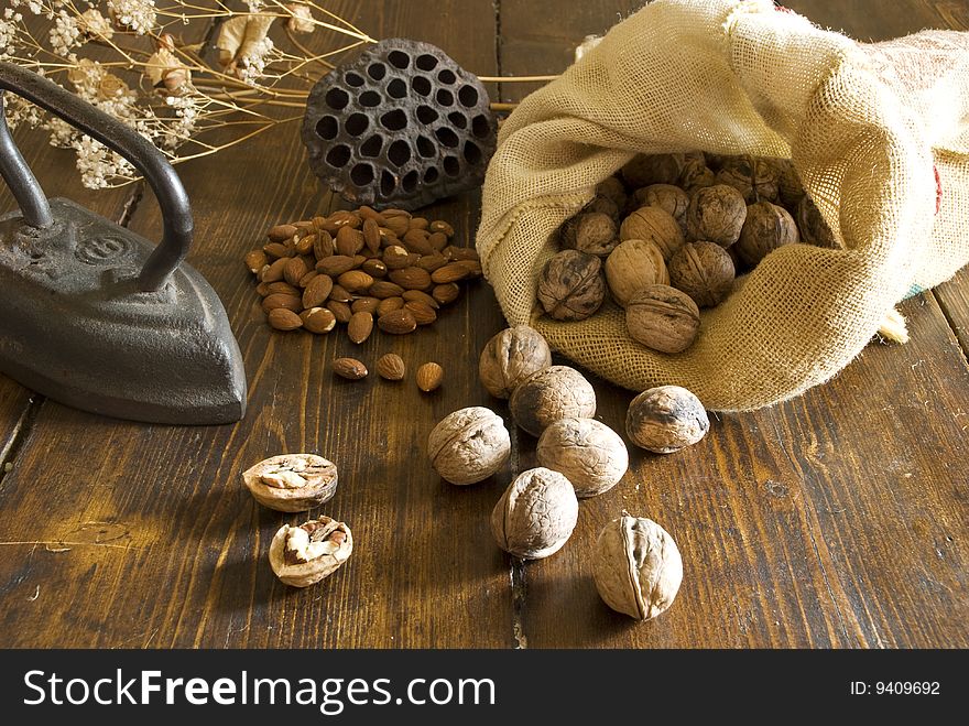 Walnuts with almond on wood surface