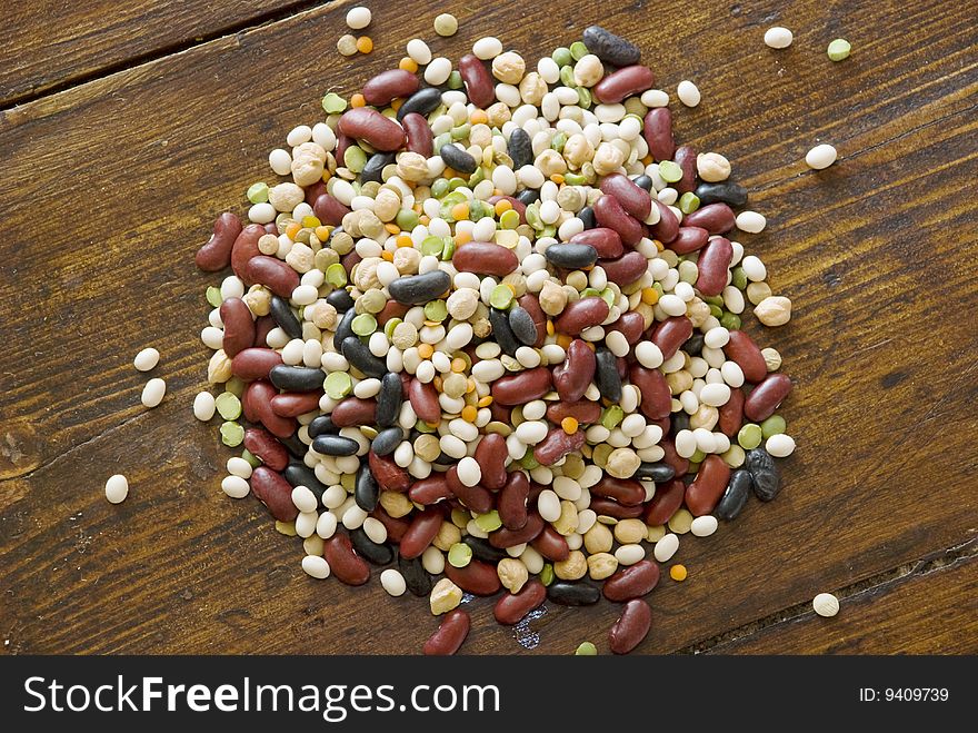 Mix of colorful beans on wood surface. Mix of colorful beans on wood surface