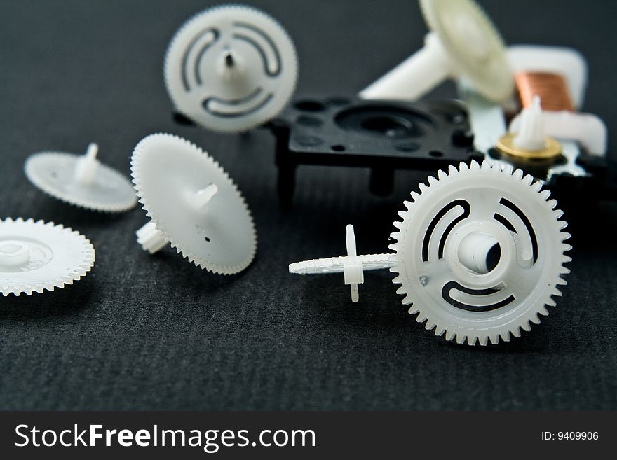 Cog-wheels from a clock on a black background