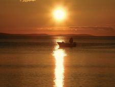 Sunset And Fisherman Stock Photo