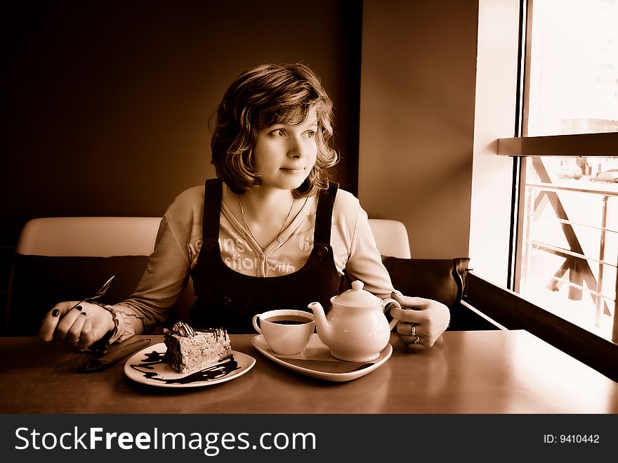 Lonely girl has lunch in small cafe near window. Lonely girl has lunch in small cafe near window