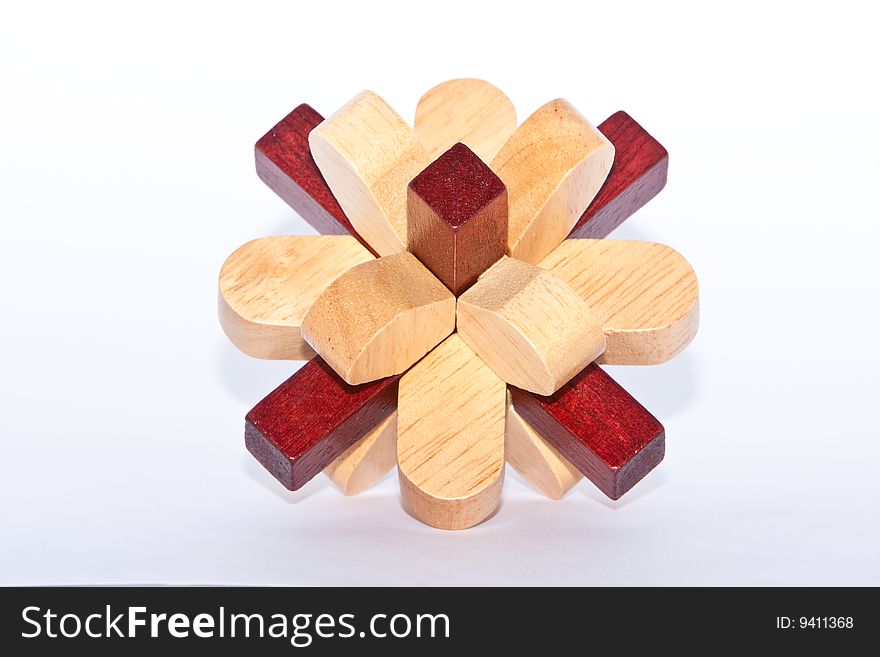 Two colored wooden burr puzzle assembled on white. Two colored wooden burr puzzle assembled on white