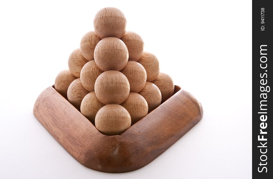 Wooden balls puzzle assembled on white background. Wooden balls puzzle assembled on white background