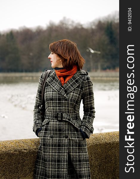 Young woman near river standing looking backward