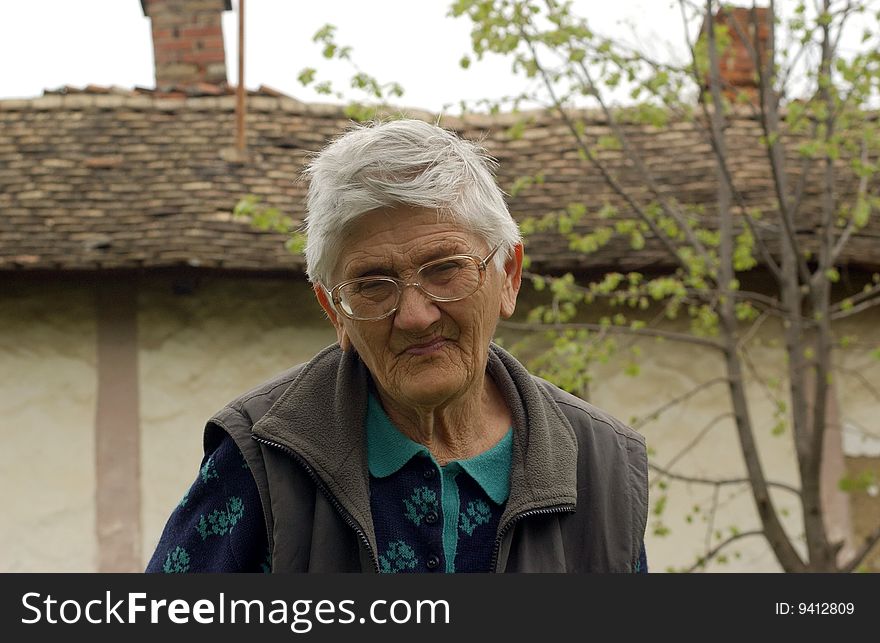 An old woman with glasses. An old woman with glasses.