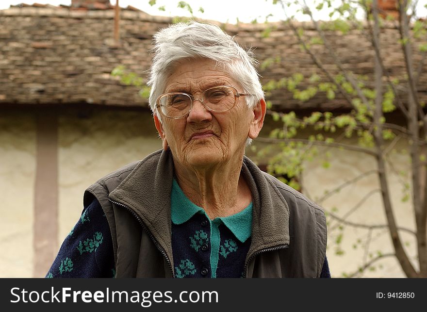 An old woman with glasses. An old woman with glasses.