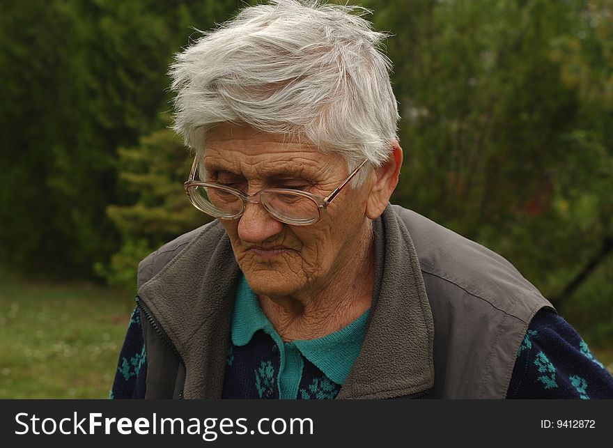 An old woman with glasses. An old woman with glasses.